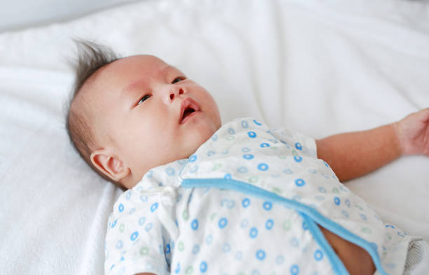istock Cute infant baby boy lying on bed. 1680340625