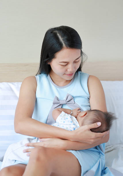 istock Young mother breast feeding her newborn child. 1680342079