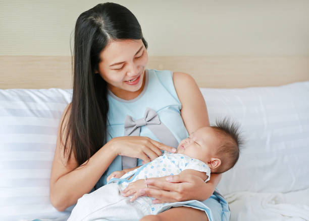 istock Mother carry sleeping baby at the bed room. 1680343580