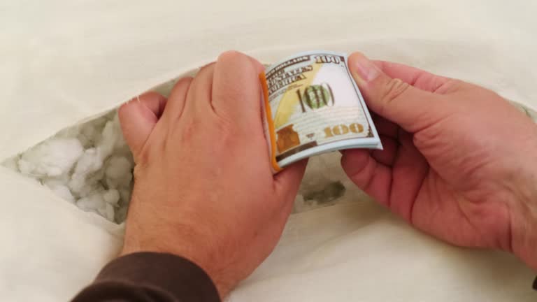 The money in dollars usa is hidden in a stash in the pillow. A torn pillow with banknotes