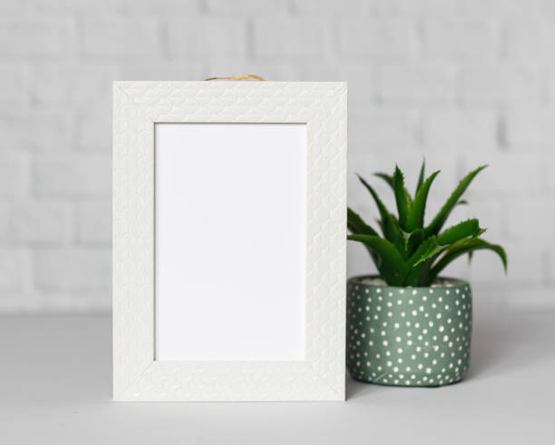 istock Minimal wooden picture poster frame mockup on white wallpaper 1680375732