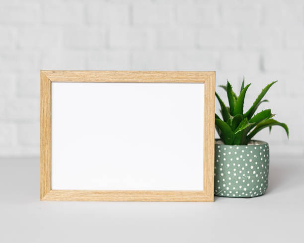 istock Minimal wooden picture poster frame mockup on white wallpaper 1680376295