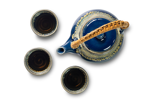 Top view of blue ceramic tea set with cups isolated on white background with clipping path.
