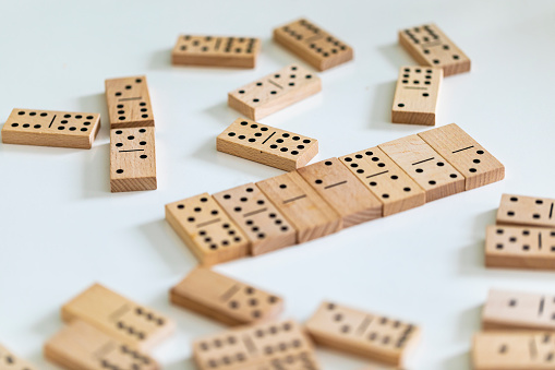 Classic wooden domino tiles on white background, closeup