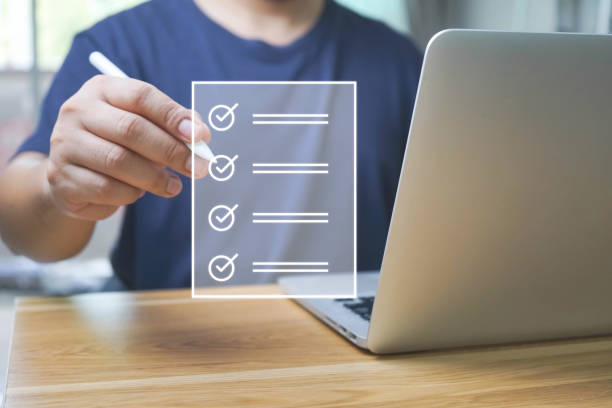 istock Business performance checklist, Quick checklist and clipboard management concept, job applicants, businessman using laptop doing online checklist survey,Employees must complete the online survey form. 1680419616