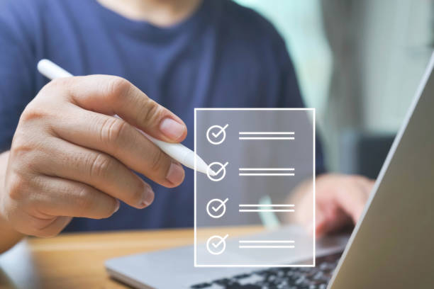 istock Business performance checklist, Quick checklist and clipboard management concept, job applicants, businessman using laptop doing online checklist survey,Employees must complete the online survey form. 1680419618