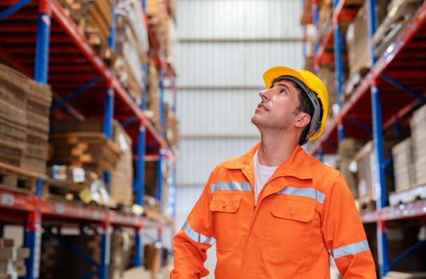 istock Efficient manufacturing and logistics within the corrugated industry. Warehouse manager walking in a storage area, diligently using a digital tablet to oversee production control. Neatly organized shelve and stacks of cardboard boxes controlled successful 1680444354