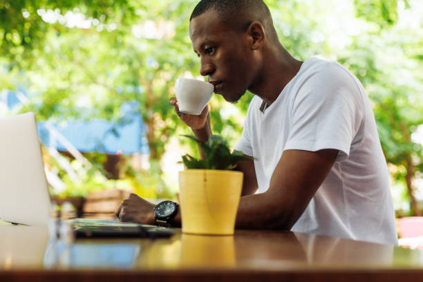 istock Confident and successful multiracial businessman drinking coffee and work, chatting online using laptop in street cafe 1680449310