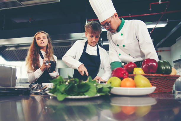 istock the group children in class kitchen room. Chef preparing student for learning marking and cooking food at workshop. 1680466195