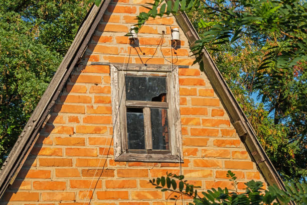 istock A small abandoned red brick house with a broken window and torn wires 1680481692