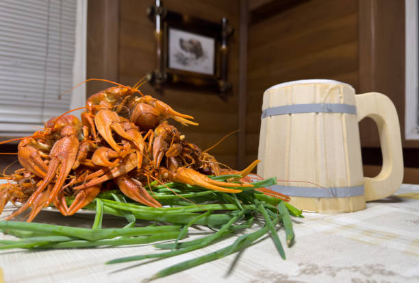 istock Crawfish with wooden beer cup on plate on table. Crawfish Snack to beer. 1680486578