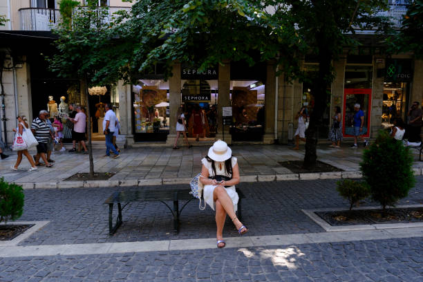 A woman in main streets during a hot day in old town Corfu, Greece on September 1, 2023.