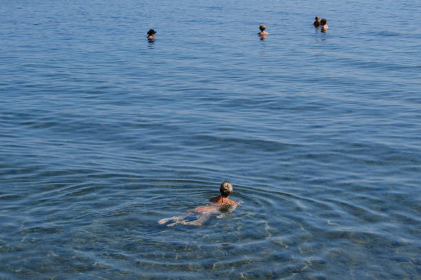 People enjoy the sunny weather as they swim in the sea in Corfu, Greece on September 2, 2023.