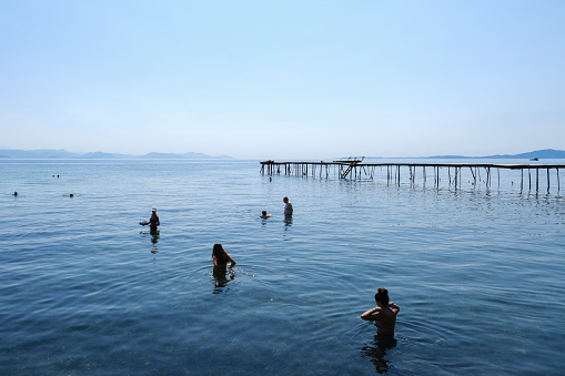 People enjoy the sunny weather as they swim in the sea in Corfu, Greece on September 2, 2023.