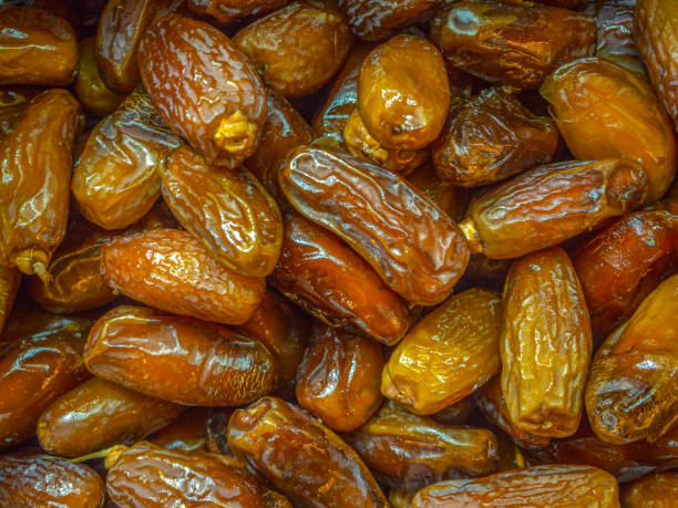 istock Ripe, sweet, brown dates are piled up in clusters. 1680499032