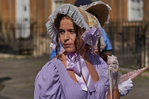 Bath, England, United Kingdom - 9 September 2023: Parade of people dressed in period costume from the Georgian era as part of the annual Jane Austen festival in Bath in Somerset, United Kingdom