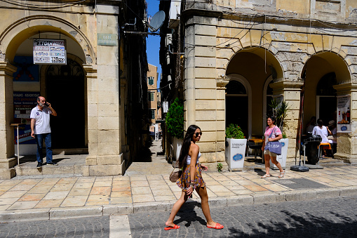 Tourists walk during a hot day in old town Corfu, Greece on September 1, 2023.