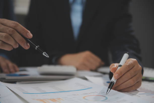 istock Financial analysts analyze business financial reports on a digital tablet planning investment project during a discussion at a meeting of corporate showing the results of their successful teamwork. 1680510189