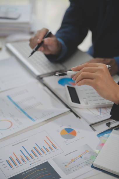 istock Financial analysts analyze business financial reports on a digital tablet planning investment project during a discussion at a meeting of corporate showing the results of their successful teamwork. 1680510231