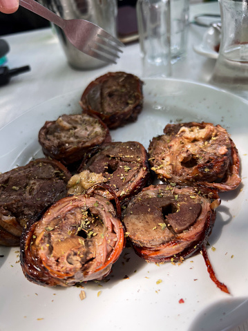A greek traditional food kokoretsi served in restaurant in Gramme,i Oxya, Greece on August 14, 2023.