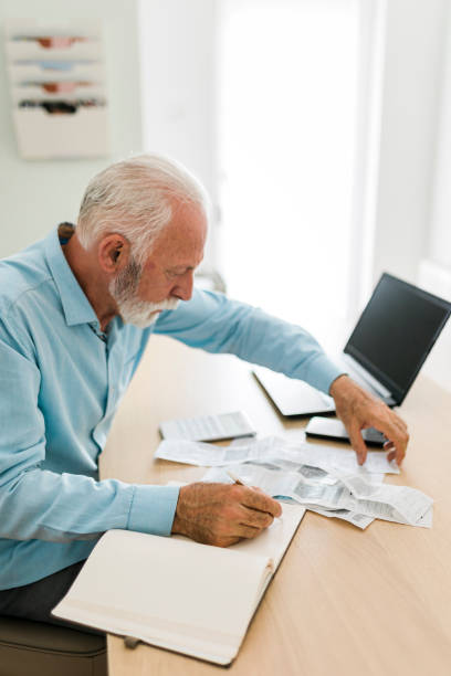 istock Senior man checking bills at home office 1680524743
