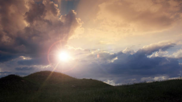 istock A hill at sunrise with storm clouds and rays 1680539593