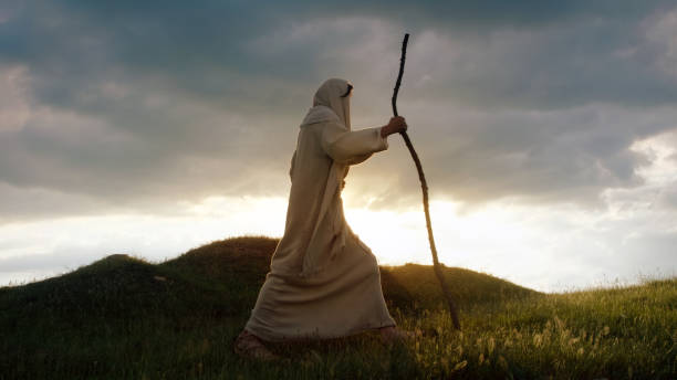 istock Christ silhouette ascending a hill with sun behind Him 1680540147