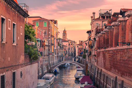 Dramatic morning light over a narrow channel at Venice, Italy