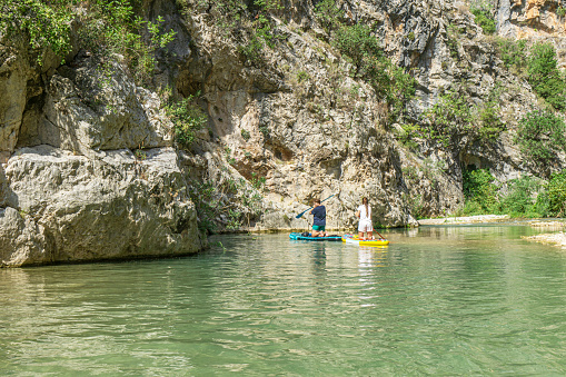 Kapuz Kanyonu, Antalya, Türkiye-September 10, 2023: people paddling with sup and enjoying the outdoors between Kapuz Canyon and Güver Canyon in the river, Antalya, Turkey