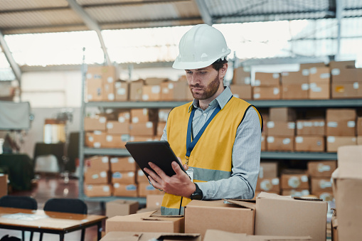 Inventory management, tablet and man with stock, logistics and track storage online in industrial manufacturing business. Factory, employee or manager with tech for shipping or cargo distribution