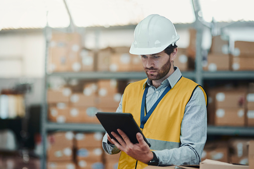 Warehouse, inventory and man with tablet for stock, logistics and track storage online in industrial manufacturing business. Factory, employee or manager with tech for shipping or cargo distribution