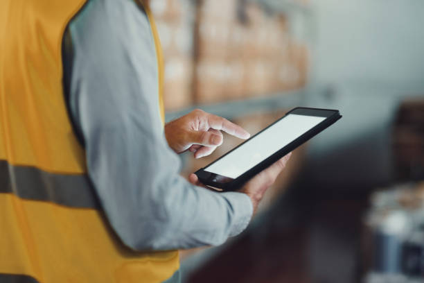 istock Warehouse tablet, screen and hands of engineer to check stock, inventory or freight. Tech, worker and man in factory by boxes in supply chain, logistics or industrial storage of cargo on mockup space 1680562255