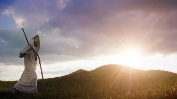 istock Christ silhouette ascending a hill at sunrise 1680563220