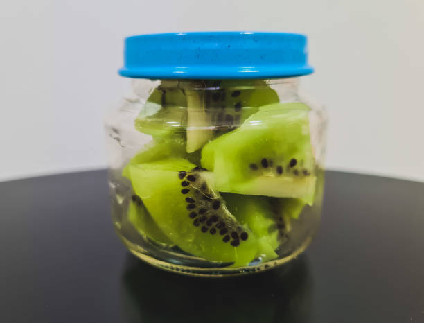 Healthy snack - kiwi in a small glass jar Kiwi in a small glass jar to serve as a healthy snack. mini kiwi stock pictures, royalty-free photos & images