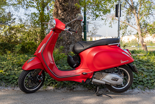 Budapest, Hungary - April 23, 2023: A picture of a red Vespa scooter.