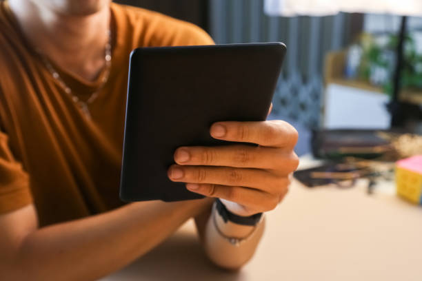 istock Reading E-book with Amazon paperwhite 3 Kindle stock photo 1680592837