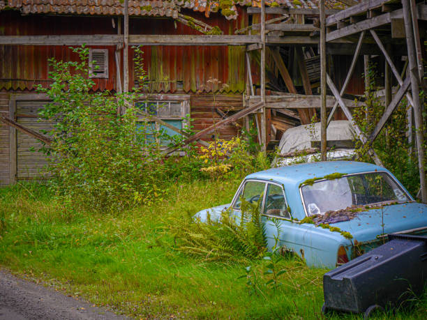 istock an old car by abandoned building 1680607011