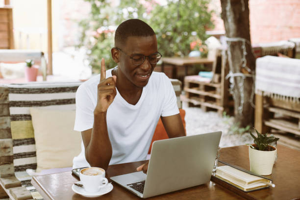 istock Inspired, smiling multicultural, mix raced man indexing and pointing up, getting new ideas. Studying online, e-learning 1680611580