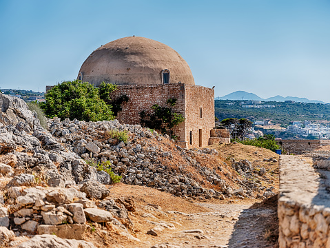 The dome of the Sultan Ibrahim Mosque in Rethymno, Crete stands amid the rubble of other buildings near the center of the city.