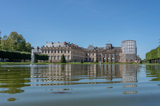 Luneville, France - 09 02 2023: View of Luneville castle reflecting on the water from the yard