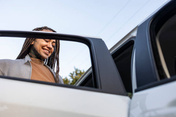 istock Black woman boarding a car via app 1680638484