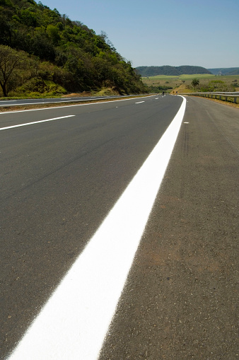 Asphalt road with white marking lines