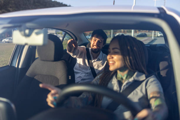 istock Woman driver of car with passenger 1680639603