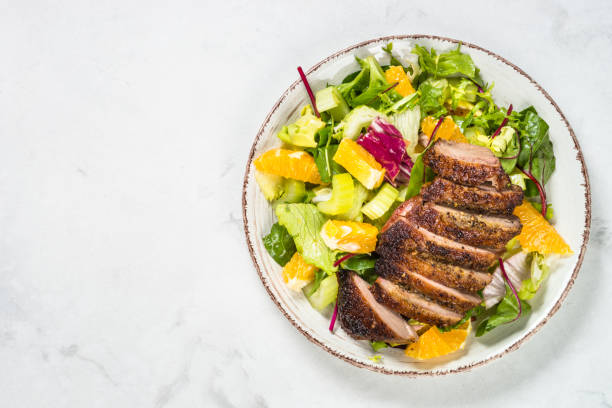 istock Salad with baked duck, green salad mix and oranges. 1680659751