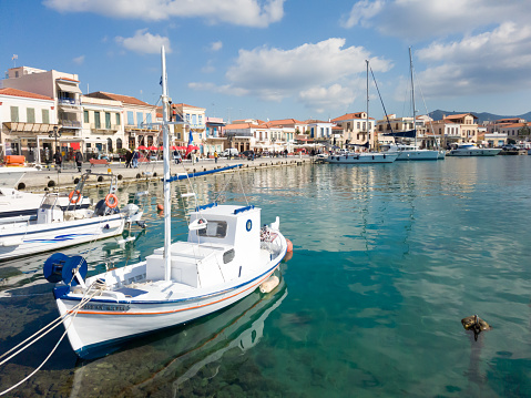 Aegina, Greece - February, 9 2020: View of Aegina's seafront. Small fishing boats docked in port of Aegina island, Greece.