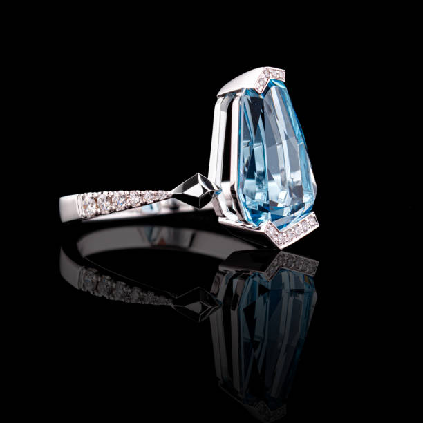 istock beautiful white gold ring with diamonds and aquamarine on a black background 1680678496