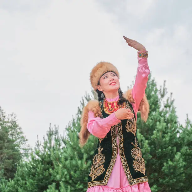 Photo of Asian girl in traditional festive Bashkir clothes dancing