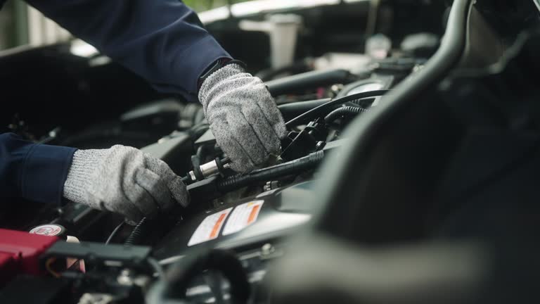 Car mechanic female repairing car.