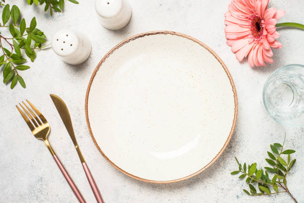 istock Table setting with white plate, cutlery and flowers. 1680720680