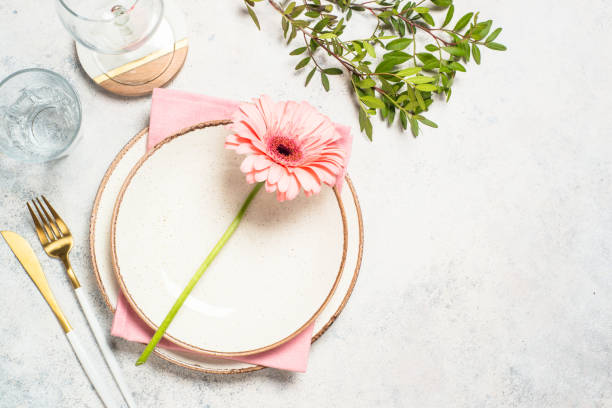 istock Table setting with white plate, cutlery and flowers. 1680721726